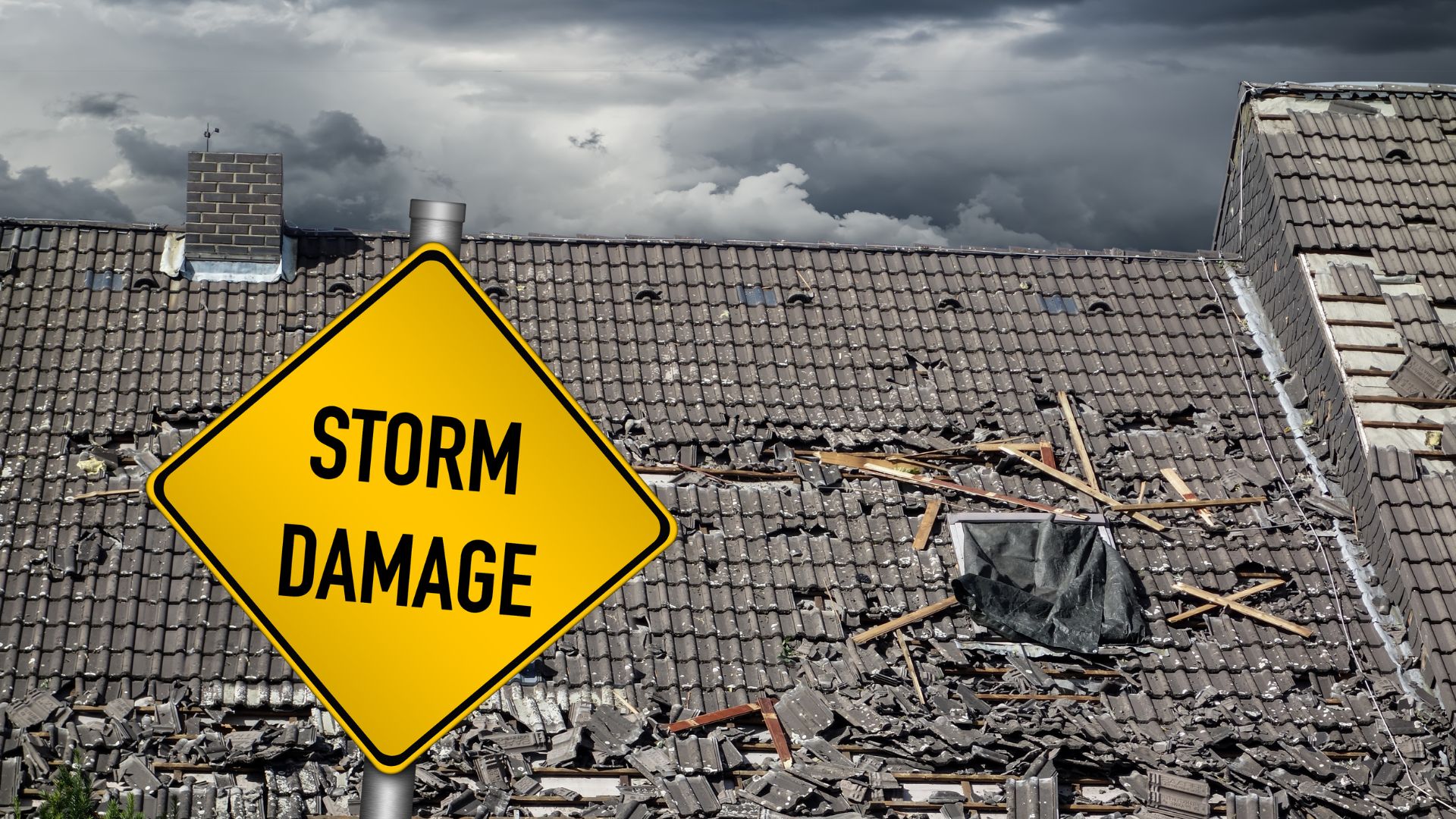 A yellow storm damage sign sitting on top of a roof